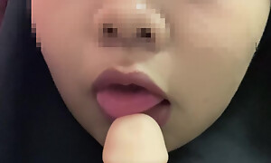 Hijabi malay sucking dildo