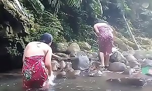 Comely girls having bath outdoor